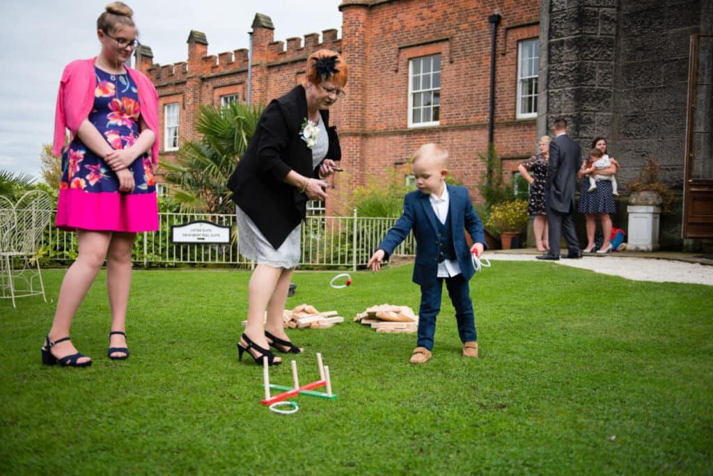 Women playing game with child on lawn